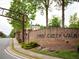 Image of Johns Creek Walk street view with landscaped entrance and signage at 11255 Knollwood Bnd, Johns Creek, GA 30097