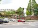 View of street at Johns Creek Walk with cars, trees, and a decorative metal bridge at 11255 Knollwood Bnd, Johns Creek, GA 30097