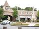 Attractive retail entrance with clock tower, fountain, landscaping, and view of Lululemon store at 11255 Knollwood Bnd, Johns Creek, GA 30097
