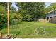Lush backyard with mature trees, play equipment, trampoline, and ample green space at 307 S Mcdonough St, Decatur, GA 30030