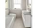 Bright bathroom with vanity, integrated sink, and modern tiling near tub and shower at 307 S Mcdonough St, Decatur, GA 30030