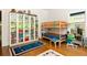 Bright bedroom with a bunk bed, white shelving, hardwood floors, and lots of storage at 307 S Mcdonough St, Decatur, GA 30030