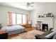 Cozy bedroom featuring a decorative fireplace, hardwood floors, and comfortable seating at 307 S Mcdonough St, Decatur, GA 30030