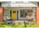Charming front porch with a yellow door, swing, brick accents, and an inviting sitting area at 307 S Mcdonough St, Decatur, GA 30030