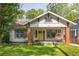 Charming craftsman home with a yellow door, front porch swing, and well-manicured lawn at 307 S Mcdonough St, Decatur, GA 30030