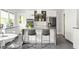 Modern kitchen featuring sleek white cabinets, stainless steel appliances, and a breakfast bar at 307 S Mcdonough St, Decatur, GA 30030