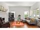 Spacious living room with hardwood floors, a fireplace, and a comfortable sectional sofa at 307 S Mcdonough St, Decatur, GA 30030