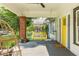 Inviting front porch with a hanging swing, ceiling fan, and charming yellow door at 307 S Mcdonough St, Decatur, GA 30030