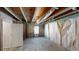 Open unfinished basement space with wooden beams, exposed ceilings, and drywall, ready for customization at 3157 Peartree Nw Dr, Acworth, GA 30101