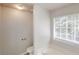 A bright bathroom features a modern toilet, and a bathtub with a window at 3157 Peartree Nw Dr, Acworth, GA 30101