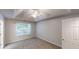 An airy bedroom boasts a tray ceiling with a fan, and a large window at 3157 Peartree Nw Dr, Acworth, GA 30101