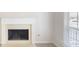 White fireplace with stone hearth and mantel next to a window and a beige carpet at 3157 Peartree Nw Dr, Acworth, GA 30101