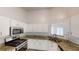 Well-lit kitchen with stainless steel appliances and granite counters; ample cabinet space at 3157 Peartree Nw Dr, Acworth, GA 30101