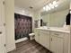 Bright bathroom with white cabinets, a modern sink, and a decorative shower curtain at 544 Magnolia Circle, Palmetto, GA 30268