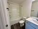 Clean bathroom featuring a shower-tub combo, a single sink vanity, and wood-look flooring at 544 Magnolia Circle, Palmetto, GA 30268