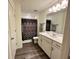 Bright bathroom with white cabinets, a modern sink, and a decorative shower curtain at 544 Magnolia Circle, Palmetto, GA 30268