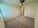 Clean bedroom with neutral carpet, a ceiling fan, and a window providing natural light at 544 Magnolia Circle, Palmetto, GA 30268