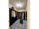 Walk-in closet featuring black built-ins and patterned flooring, illuminated by a stylish light fixture at 544 Magnolia Circle, Palmetto, GA 30268