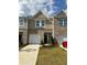 Attractive townhomes showcasing brick and siding exteriors, with green lawns and attached garages at 544 Magnolia Circle, Palmetto, GA 30268