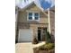 Charming townhome featuring a brick facade, attached garage, and well-maintained landscaping at 544 Magnolia Circle, Palmetto, GA 30268