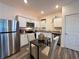 Stylish kitchen equipped with stainless steel appliances, granite countertops, and a dining space at 544 Magnolia Circle, Palmetto, GA 30268