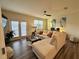 Bright living room featuring a comfortable sectional sofa, wood floors, and natural light at 544 Magnolia Circle, Palmetto, GA 30268