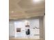 View of the basement with the kitchen area, tile floors and a walk out to the backyard at 110 Chippewa Ct, Riverdale, GA 30296