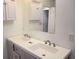 Bathroom with double sinks and white cabinetry above the sinks at 110 Chippewa Ct, Riverdale, GA 30296
