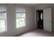 Bedroom features two windows and a door leading to another room at 110 Chippewa Ct, Riverdale, GA 30296