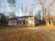 Two-story home featuring a charming front entry, nestled among mature trees and a winding driveway at 110 Chippewa Ct, Riverdale, GA 30296