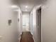 Hallway featuring hardwood floors, neutral walls, recessed lighting, and white doors at 110 Chippewa Ct, Riverdale, GA 30296