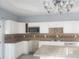 Kitchen features white cabinetry, backsplash, and modern appliances at 110 Chippewa Ct, Riverdale, GA 30296