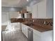 Well-lit kitchen features white cabinets, tiled backsplash, stone countertop, and stainless steel appliances at 110 Chippewa Ct, Riverdale, GA 30296