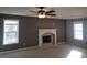 Living room with windows, gray walls, a fireplace with white mantle, ceiling fan and carpeted floors at 110 Chippewa Ct, Riverdale, GA 30296