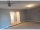 Spacious living room with neutral walls, carpeting, and a ceiling fan at 110 Chippewa Ct, Riverdale, GA 30296