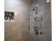 Gray tiled walk-in shower with a tile niche, shower head and shelving at 110 Chippewa Ct, Riverdale, GA 30296