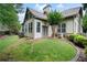 A backyard with a lush lawn, patio area, well-maintained landscaping, and mature trees at 1549 Lake Holcomb Ln, Marietta, GA 30062