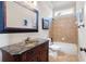 Bathroom featuring a marble vanity and tiled shower and bathtub enclosure at 1549 Lake Holcomb Ln, Marietta, GA 30062