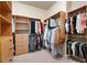 Walk-in closet with wood shelving and hanging rods for ample storage at 1549 Lake Holcomb Ln, Marietta, GA 30062