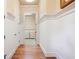 Hallway with hardwood floors leading to the laundry room featuring beadboard accent at 1549 Lake Holcomb Ln, Marietta, GA 30062