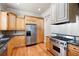 Well-equipped kitchen with stainless steel appliances, granite countertops, and wooden cabinets at 1549 Lake Holcomb Ln, Marietta, GA 30062