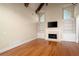 Living room featuring hardwood floors, vaulted ceilings, fireplace, and built-in shelving, creating a cozy atmosphere at 1549 Lake Holcomb Ln, Marietta, GA 30062