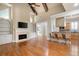 Open-concept living room boasts hardwood floors, fireplace, built-in shelves, and views into the kitchen bar area at 1549 Lake Holcomb Ln, Marietta, GA 30062