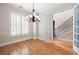 Bright room showcasing hardwood floors, white shutters, and glass pane doors to adjoining staircase hall at 1549 Lake Holcomb Ln, Marietta, GA 30062