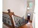 Staircase with wood treads and decorative iron spindles at 1549 Lake Holcomb Ln, Marietta, GA 30062