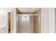 Bathroom featuring a shower stall with glass door and tiled walls at 3001 Donamire Nw Ave, Kennesaw, GA 30144
