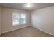 This cozy bedroom includes a window with natural light and neutral carpet at 3001 Donamire Nw Ave, Kennesaw, GA 30144