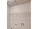 Utility room with a wire rack shelf above water connections and a ceiling access panel at 3001 Donamire Nw Ave, Kennesaw, GA 30144