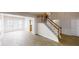 Open living room with modern flooring, staircase, and large bay window at 3001 Donamire Nw Ave, Kennesaw, GA 30144