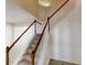 Staircase with carpet steps and white spindles, leading to the upper level at 3001 Donamire Nw Ave, Kennesaw, GA 30144